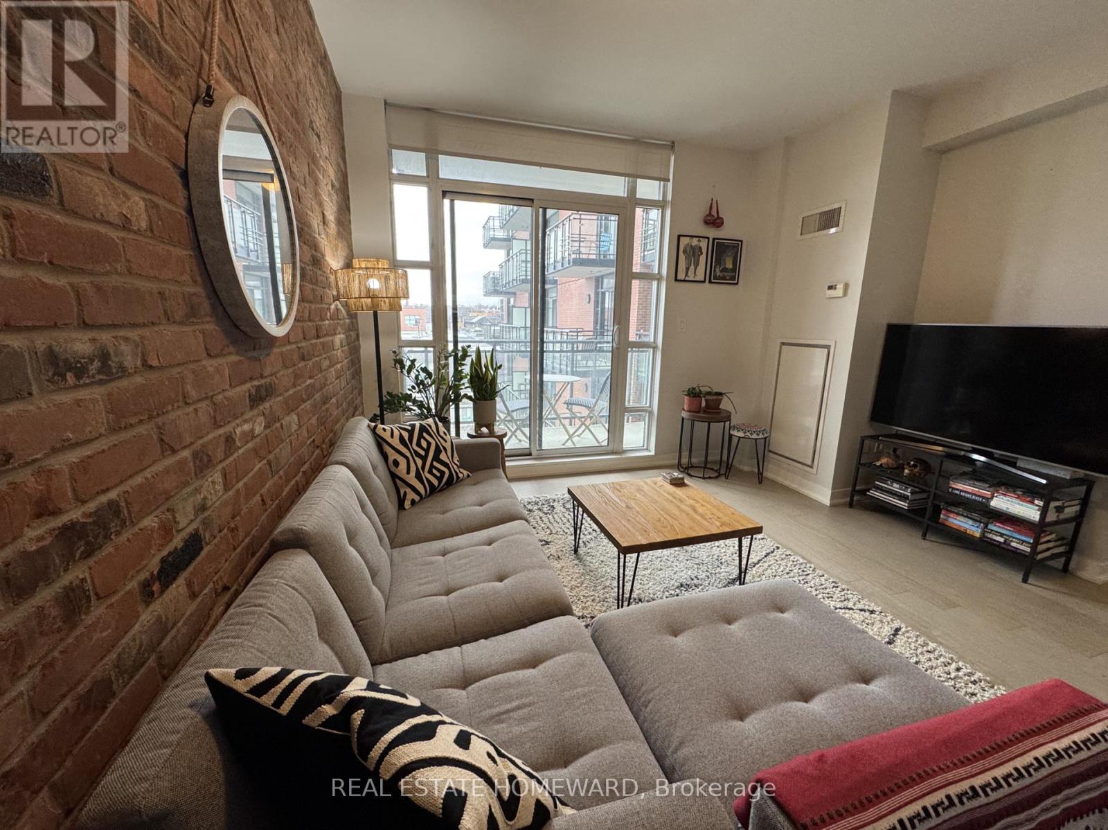 Sun-filled living with exposed brick feature