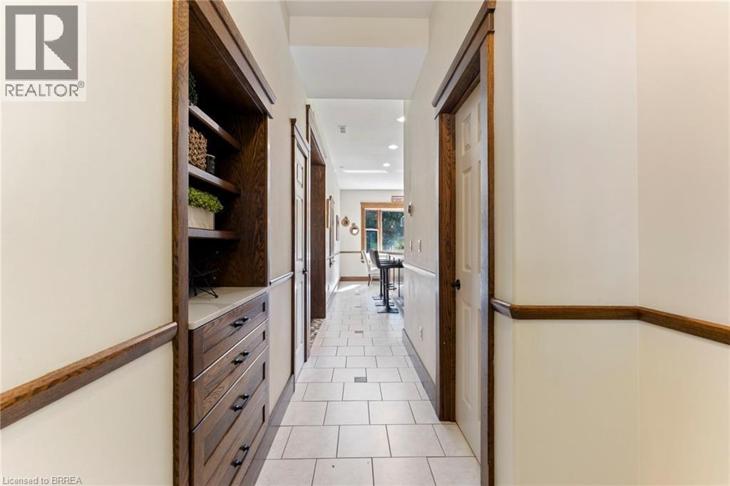 Hall with light tile patterned floors and recessed lighting