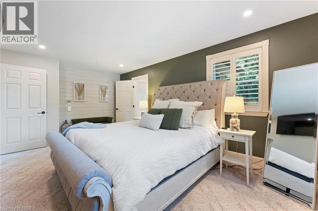 Bedroom with recessed lighting and light carpet