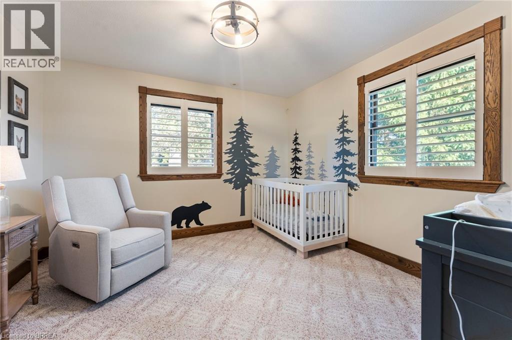 Bedroom with a nursery area and light carpet