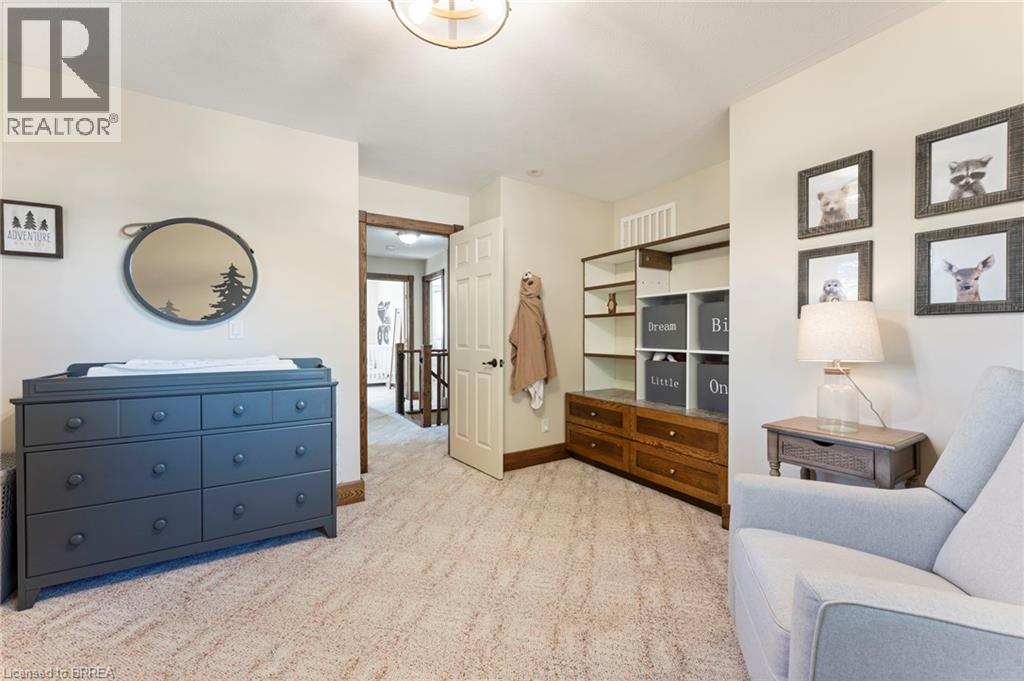 Living area with light carpet and baseboards