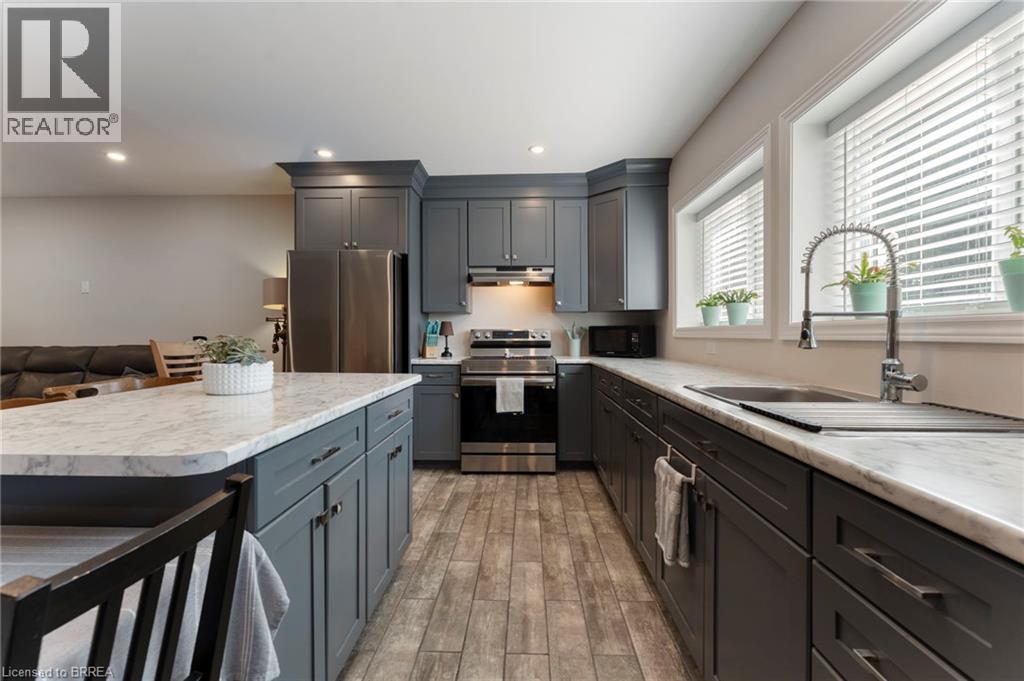 Kitchen featuring stainless steel appliances, light countertops, light wood-style floors, and recessed lighting