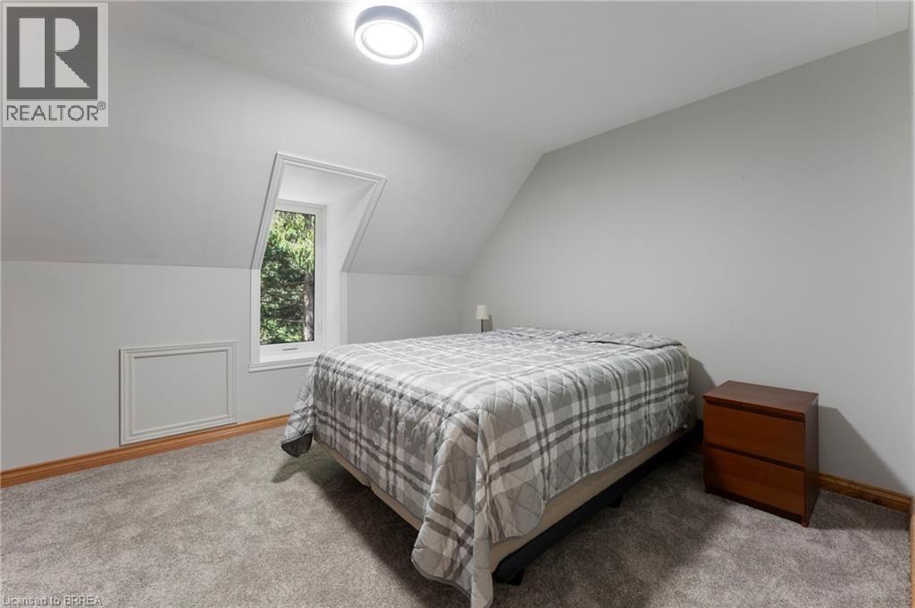 Bedroom featuring light colored carpet and lofted ceiling