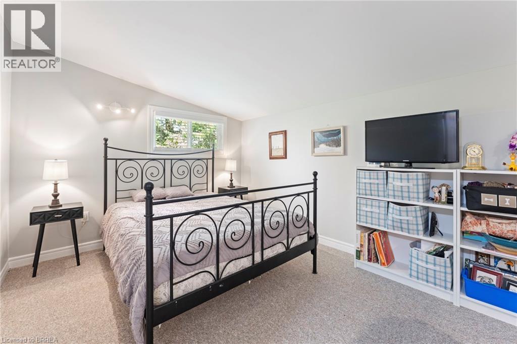 Bedroom with lofted ceiling and light colored carpet
