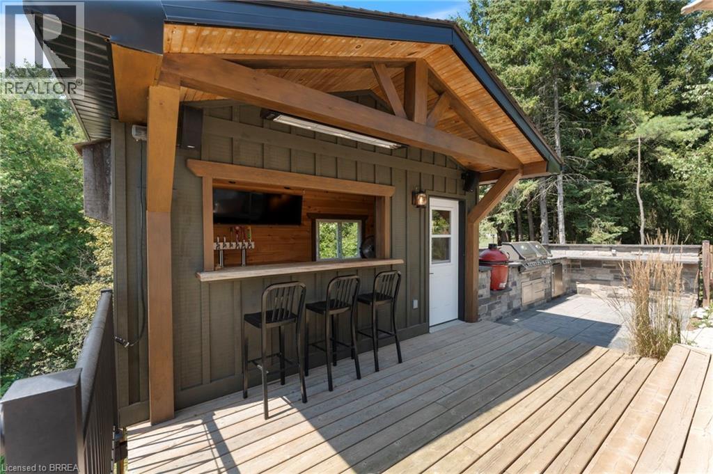Wooden deck featuring exterior kitchen
