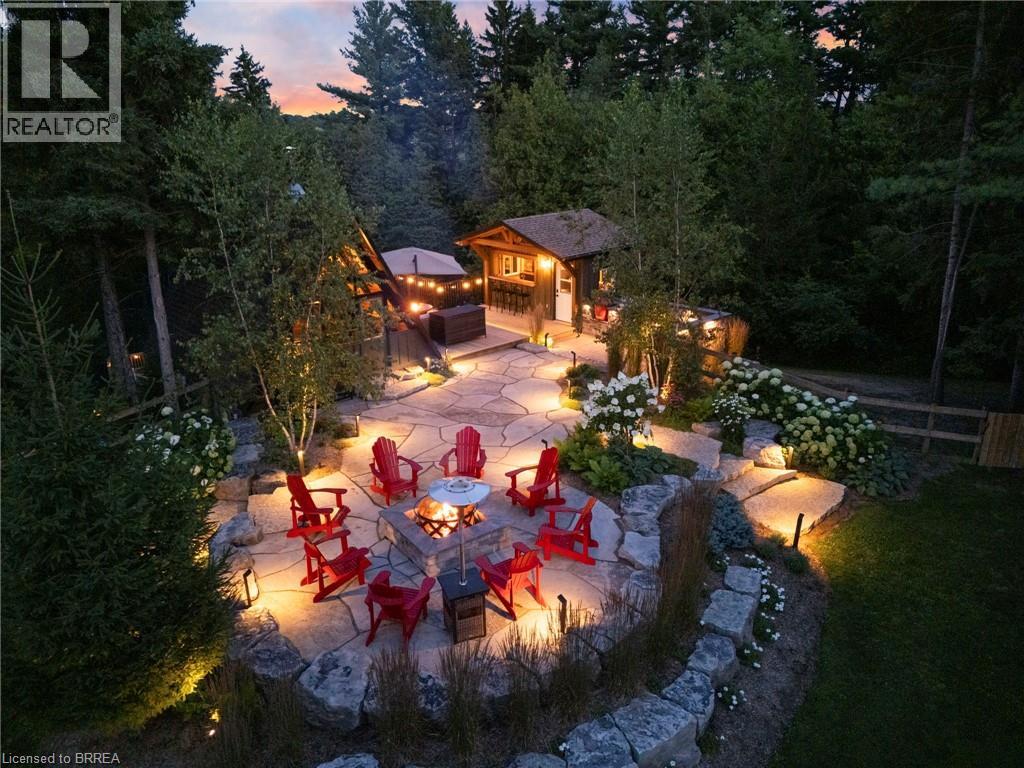 Patio terrace at dusk with a fire pit, an outdoor structure, and a patio