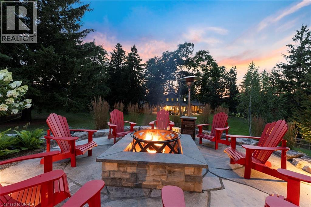 Patio terrace at dusk featuring a fire pit and a patio area
