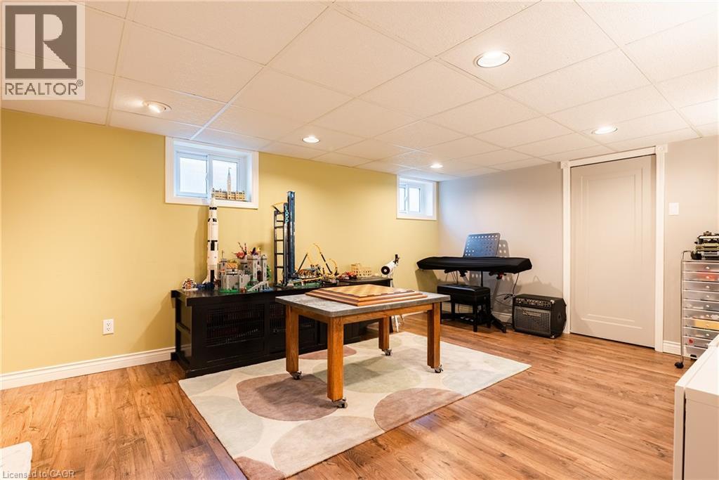 Playroom with a drop ceiling, light wood-style floors, and recessed lighting