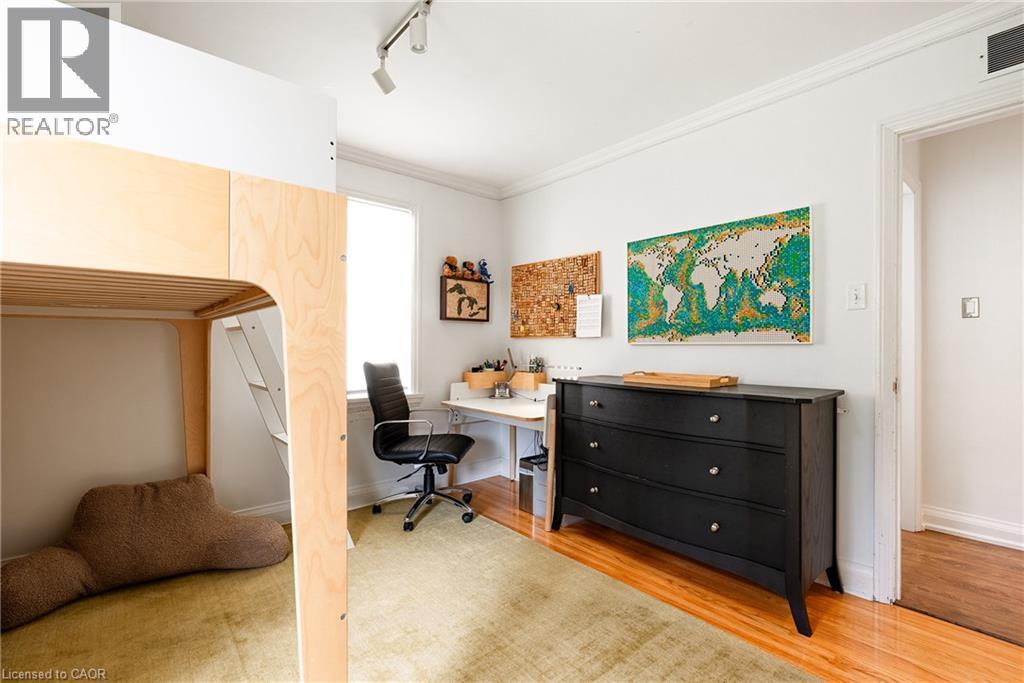 Office space featuring rail lighting, ornamental molding, and light wood-style flooring