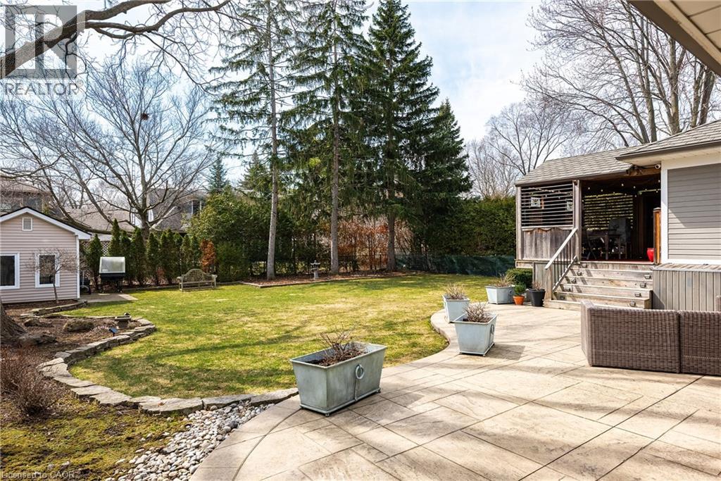 View of grassy yard featuring a patio area