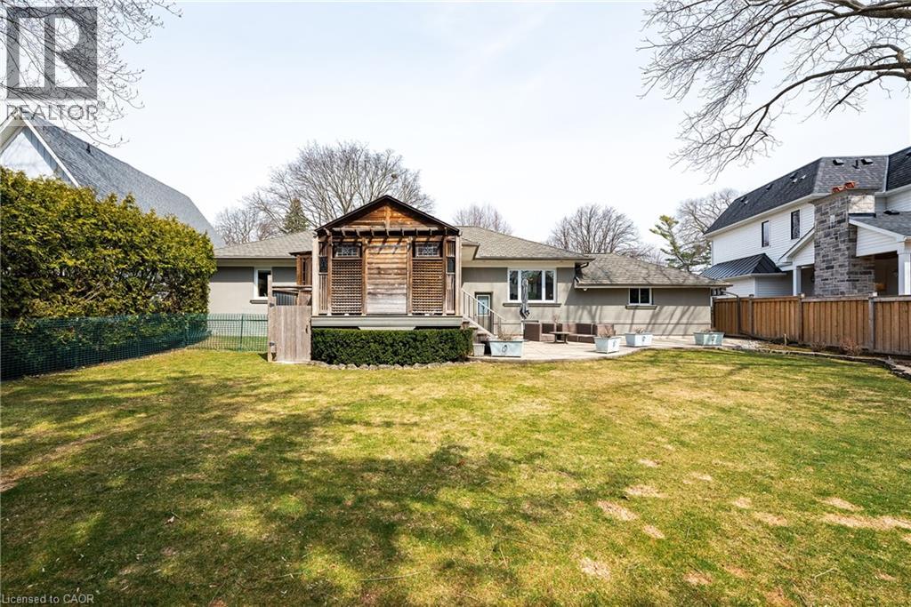 Back of house featuring a fenced backyard, a patio, and a wooden deck