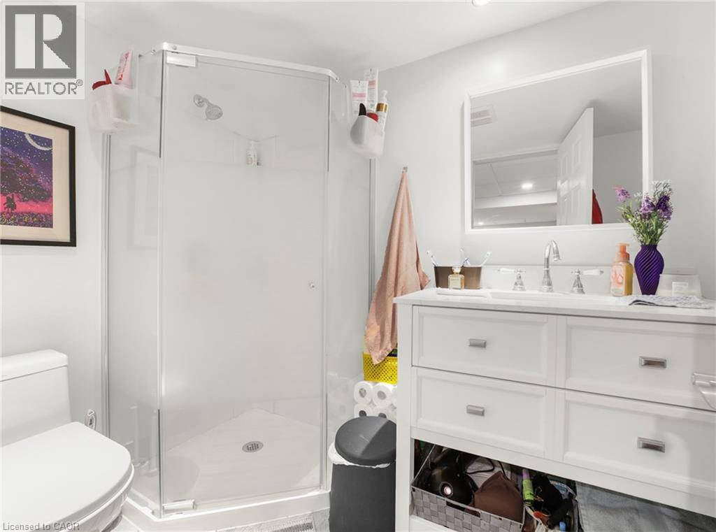 Full bathroom with vanity and a shower stall