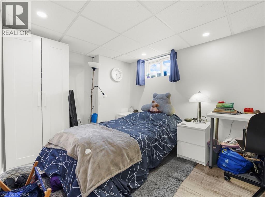 Bedroom featuring a paneled ceiling, light wood finished floors, and recessed lighting