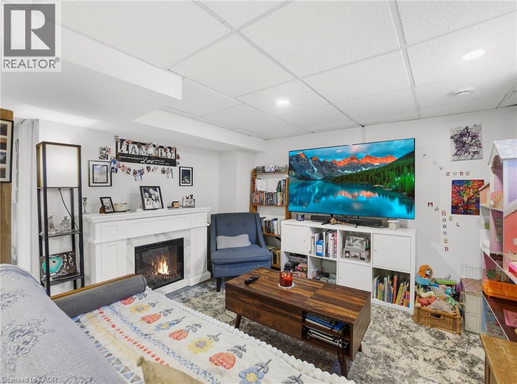 Living area featuring a drop ceiling and a premium fireplace