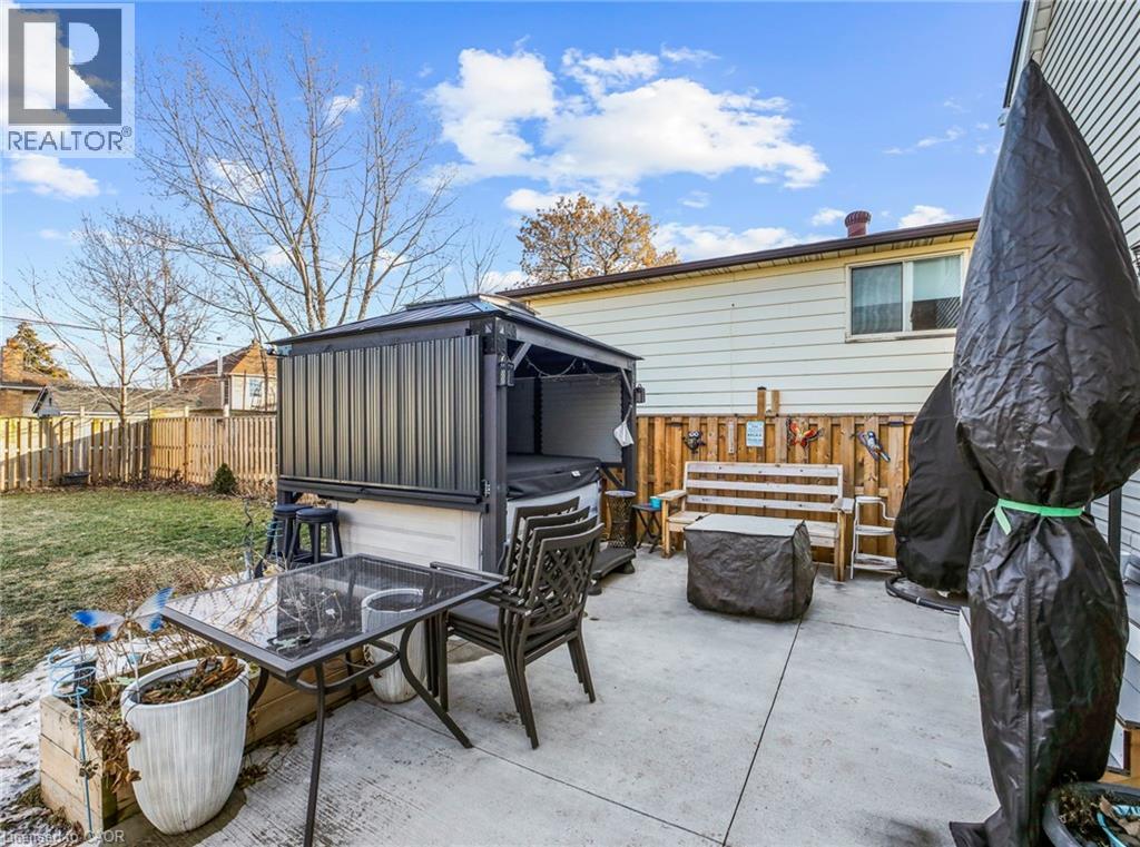 Back of house featuring a fenced backyard, a patio, and a fire pit