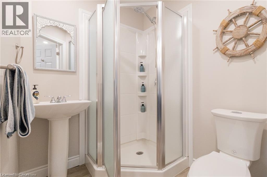 Full bath featuring toilet and a shower stall