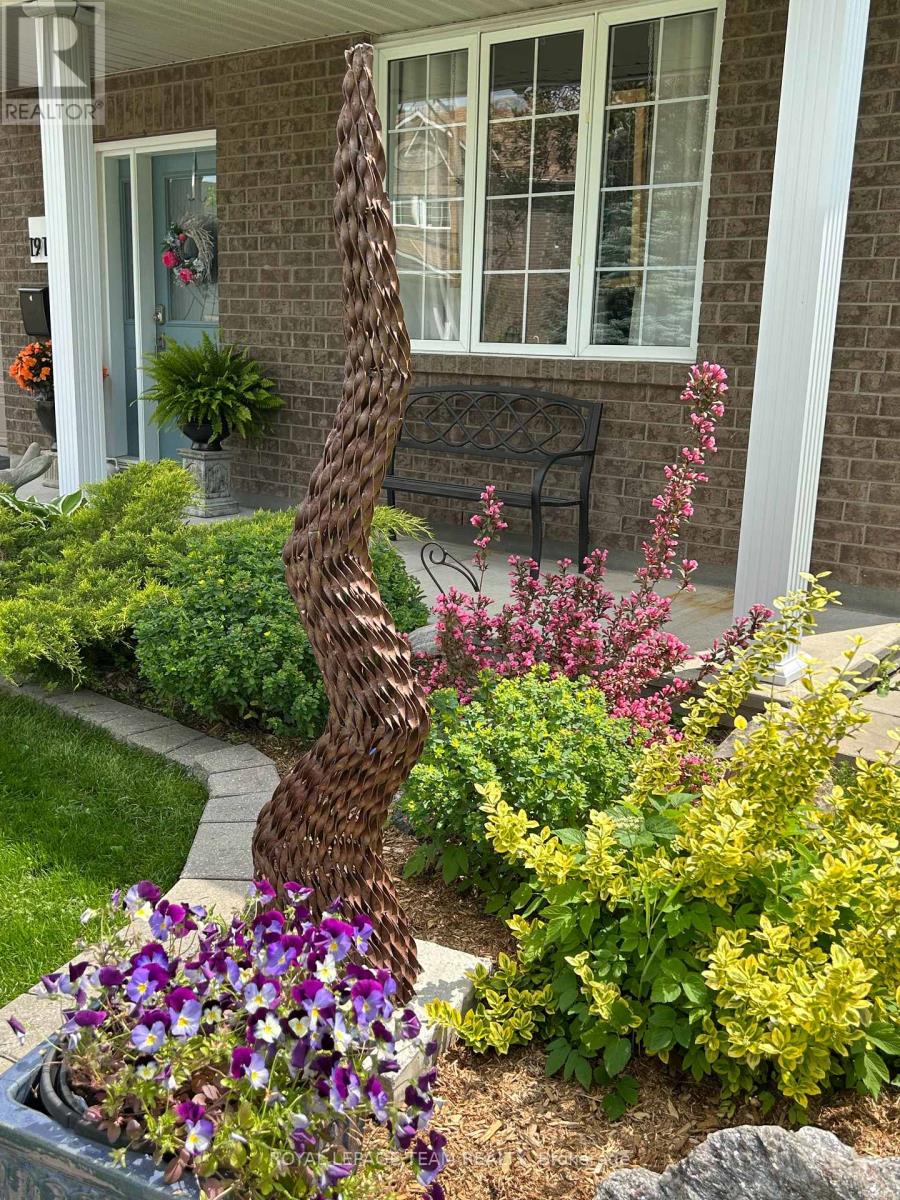 Front perennial garden is full of mature plants.