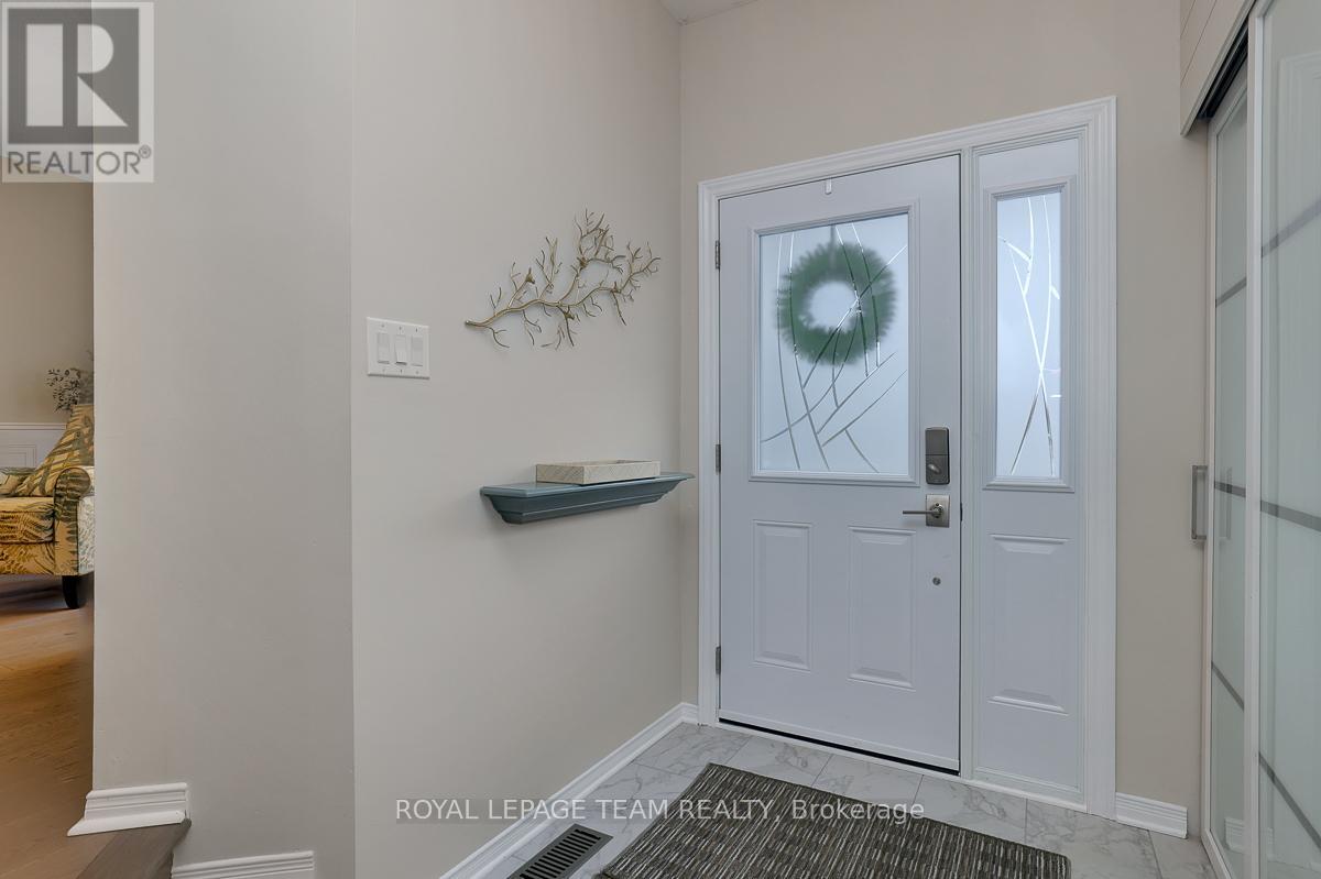 Bright foyer with newer tile and closet doors.