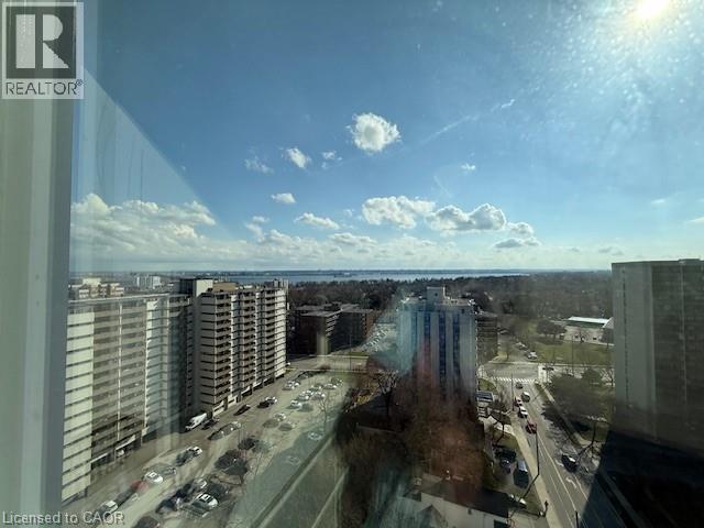 Expansive views of the surrounding urban landscape, including distant water and a clear sky with scattered clouds
