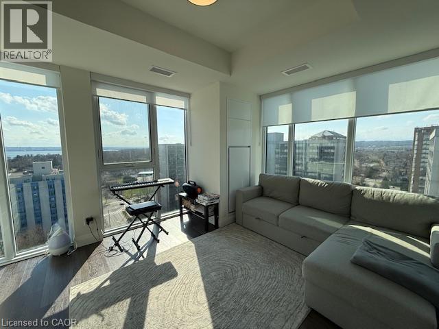 The living area features expansive windows, offering abundant natural light and panoramic city and water views