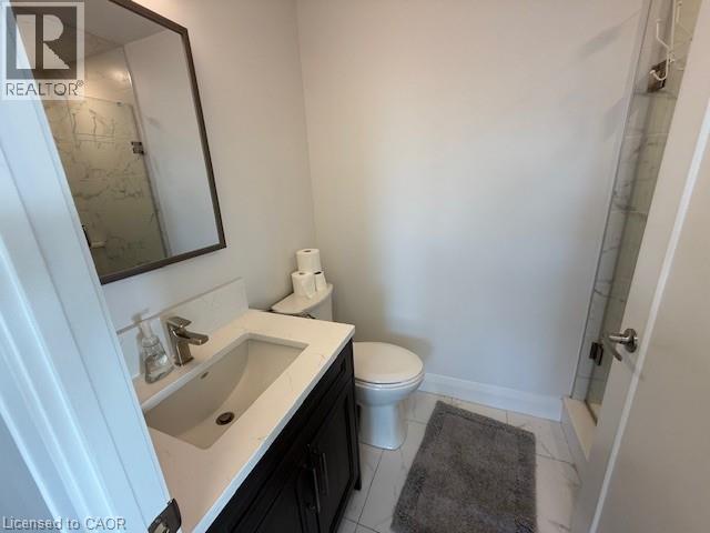This bathroom features a contemporary vanity with a white countertop and dark cabinetry