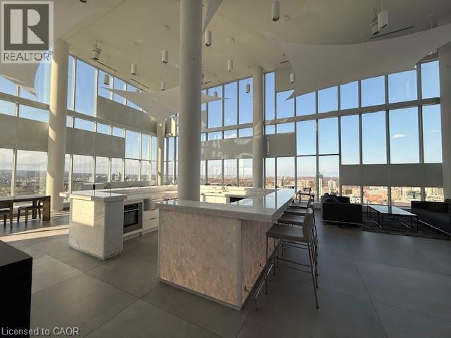 The property features an expansive open space with floor-to-ceiling windows, offering panoramic views