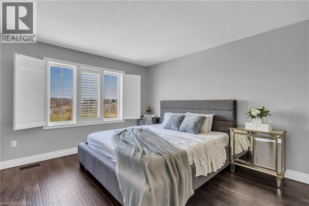 Bedroom featuring dark wood-style floors and a textured ceiling