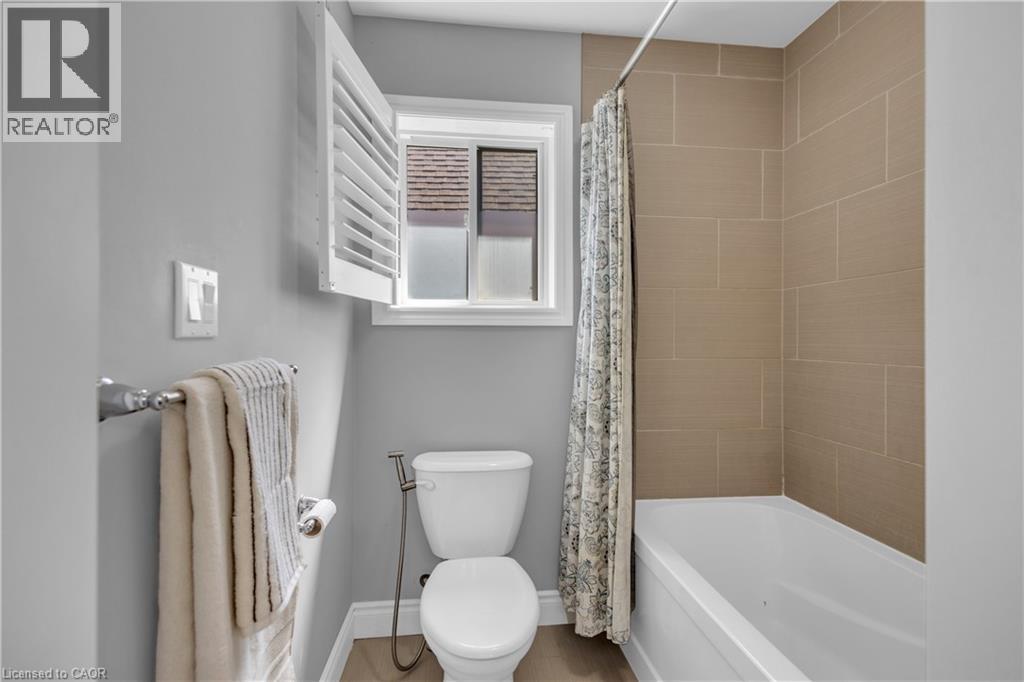 Bathroom featuring toilet and shower / bath combo