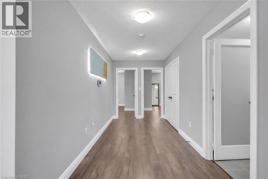 Corridor featuring dark wood-type flooring and a textured ceiling
