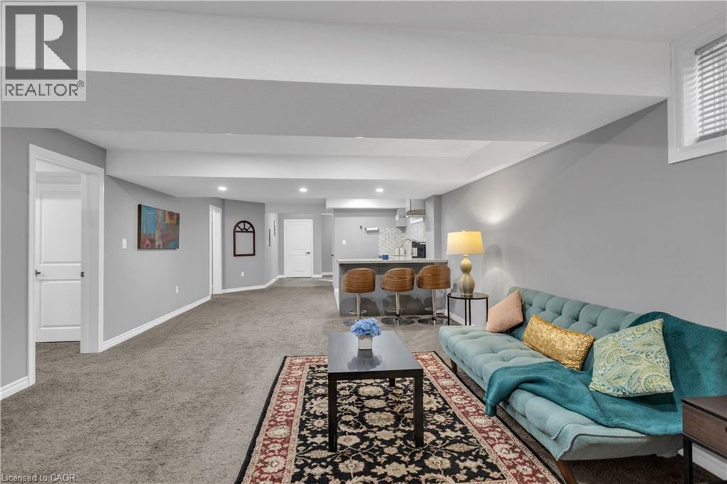 Living room featuring a bar, light carpet, and recessed lighting