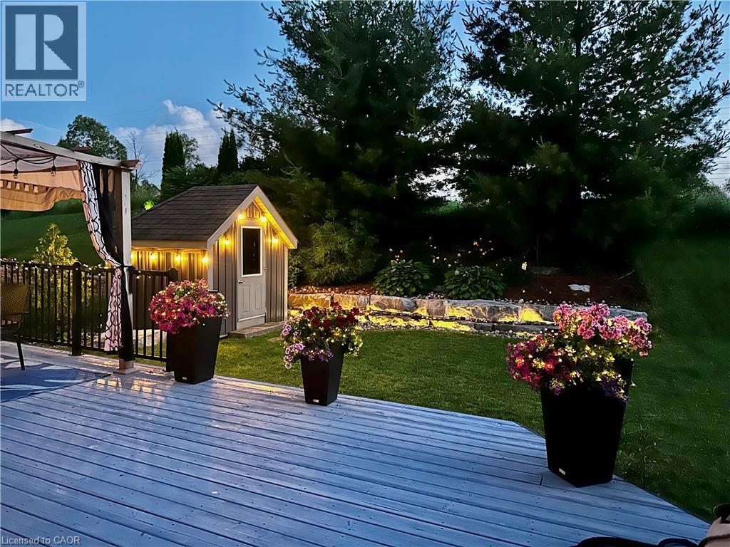 Deck with a fenced backyard and a storage shed