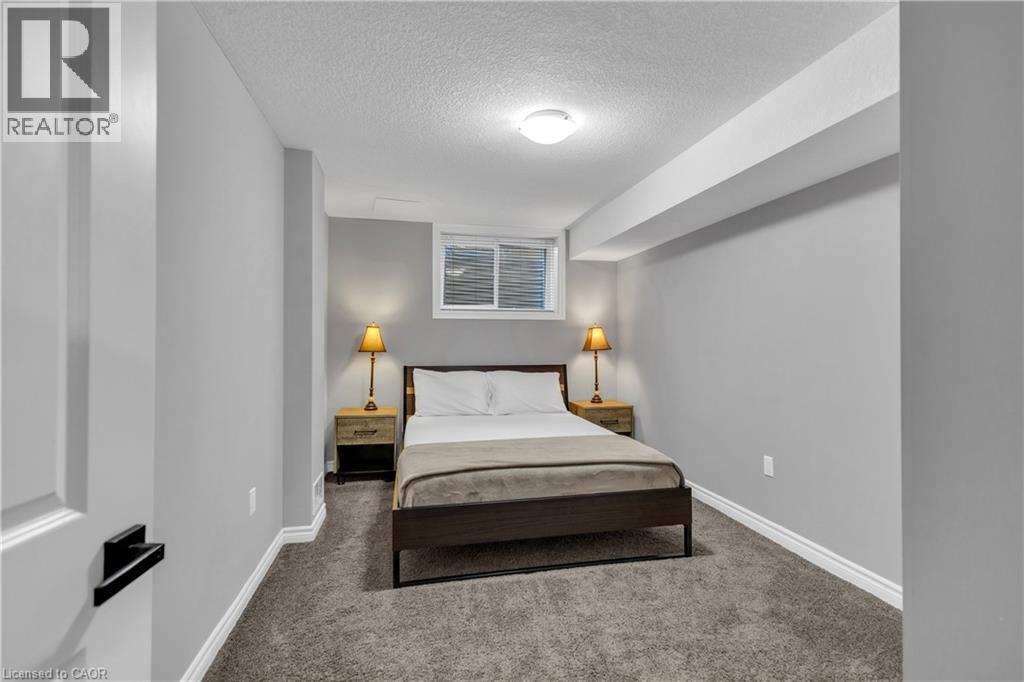 Carpeted bedroom featuring a textured ceiling and baseboards