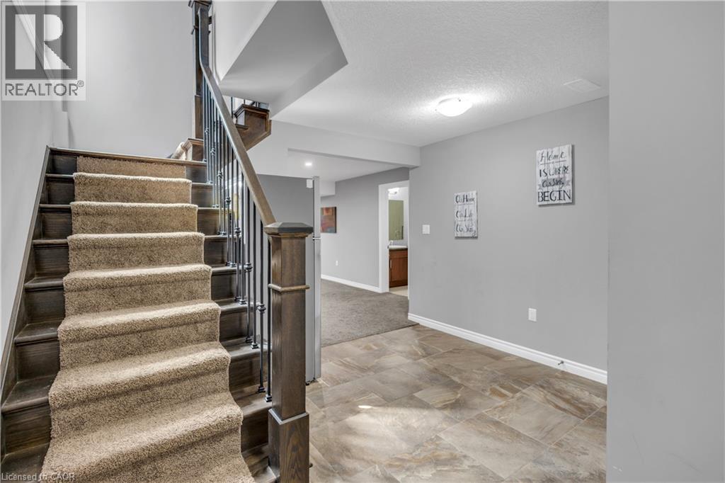 Stairs featuring baseboards and a textured ceiling