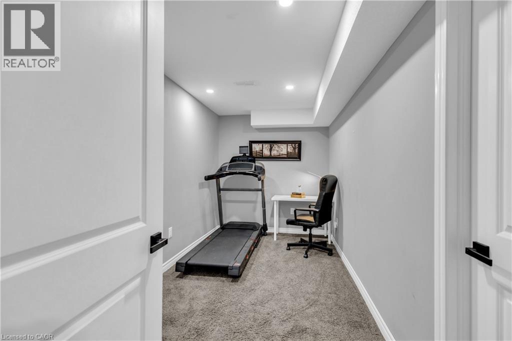 Exercise area with light colored carpet and recessed lighting