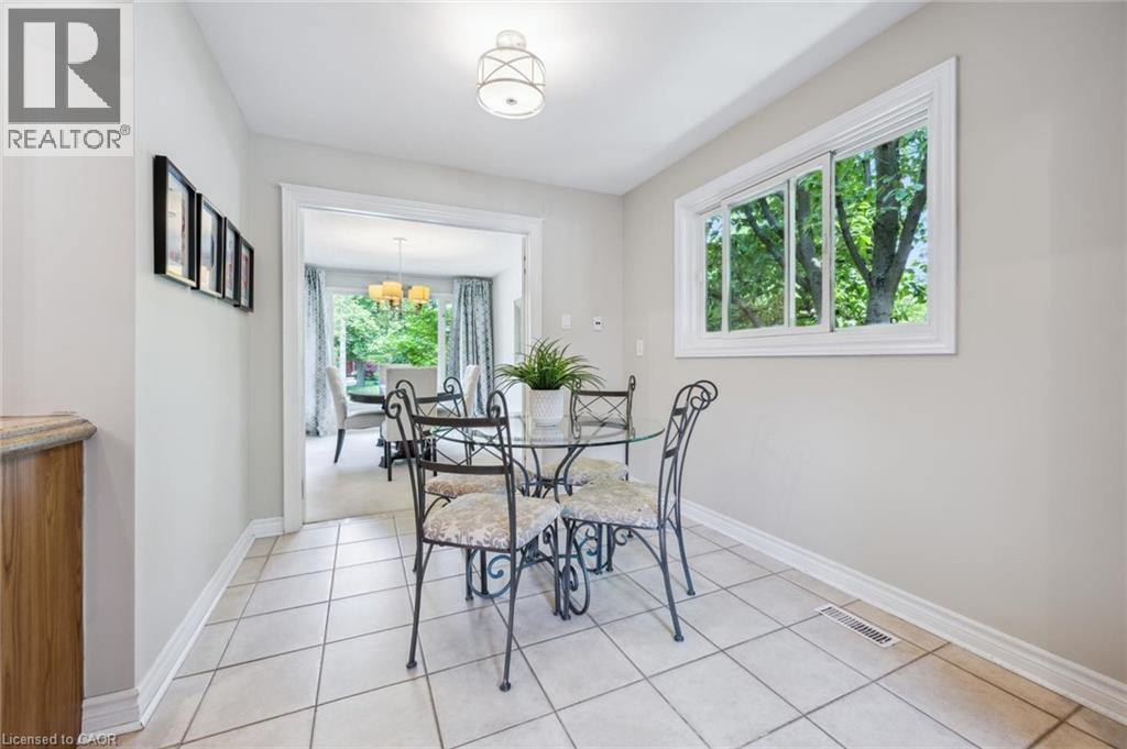 Dining space with light tile patterned floors and a chandelier