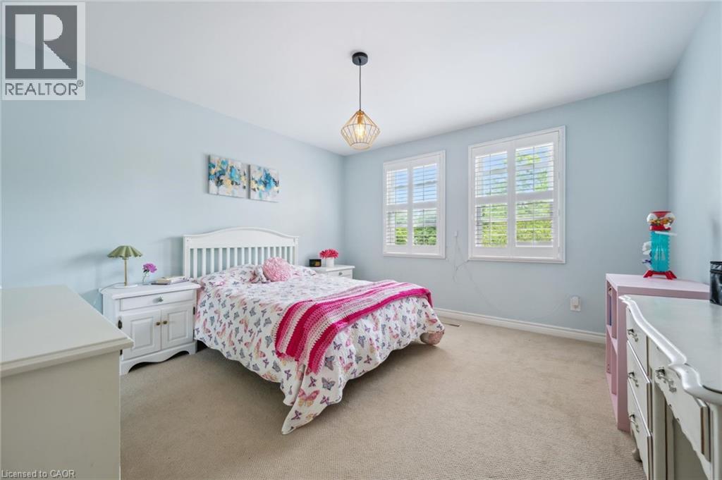 Bedroom with light colored carpet and baseboards