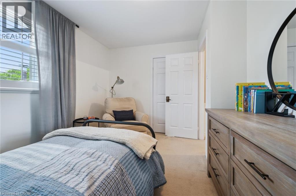 Bedroom featuring light carpet