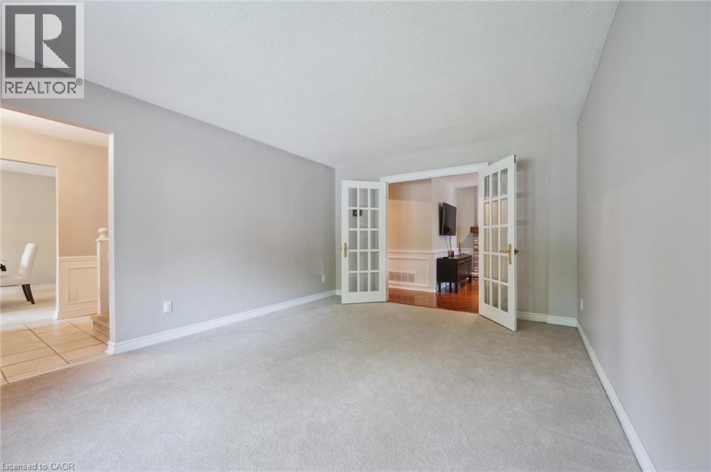 Empty room with light carpet and french doors