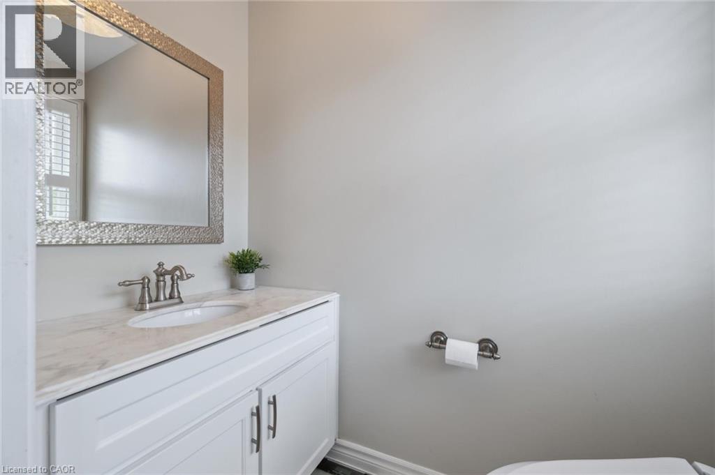 Half bathroom with vanity and baseboards