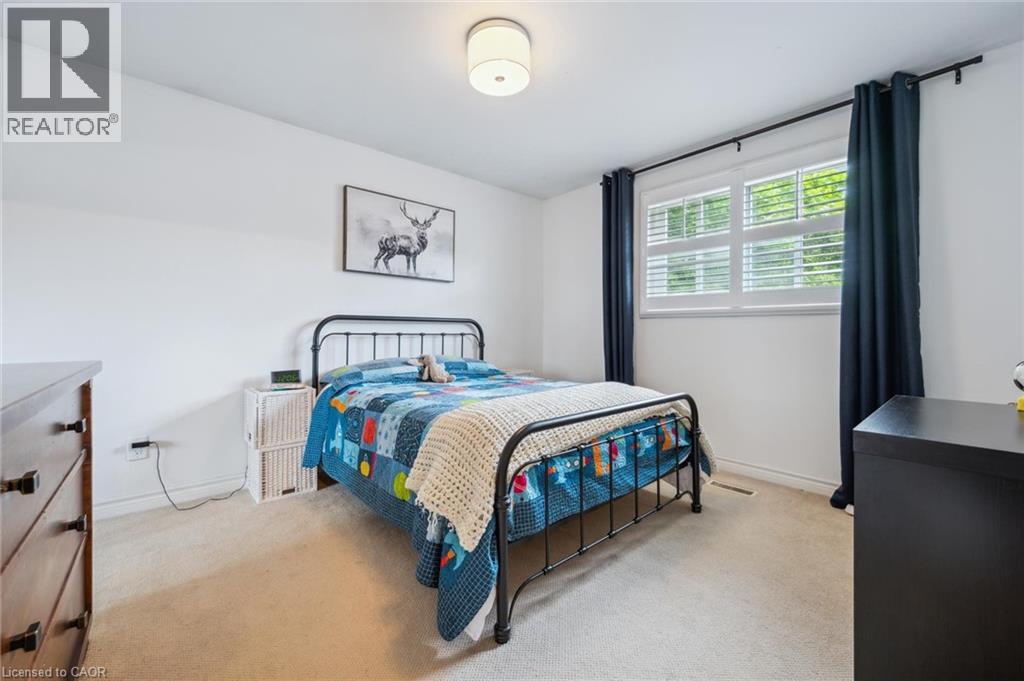 Bedroom featuring light carpet and baseboards