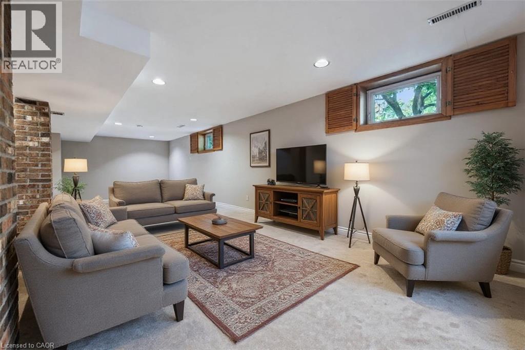 Living area featuring light colored carpet and recessed lighting