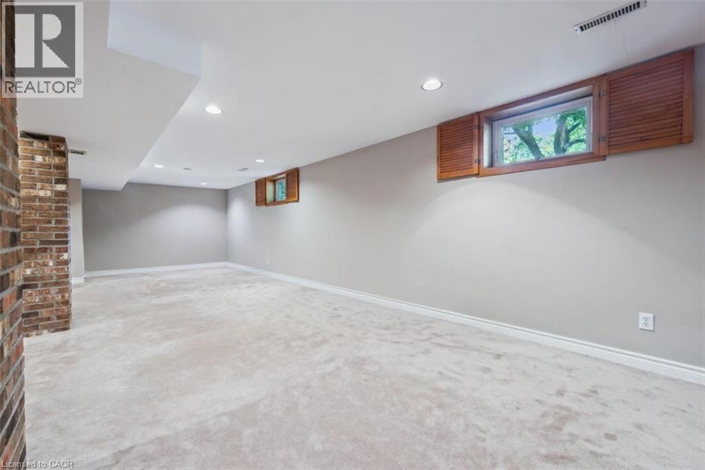Basement with light colored carpet and recessed lighting