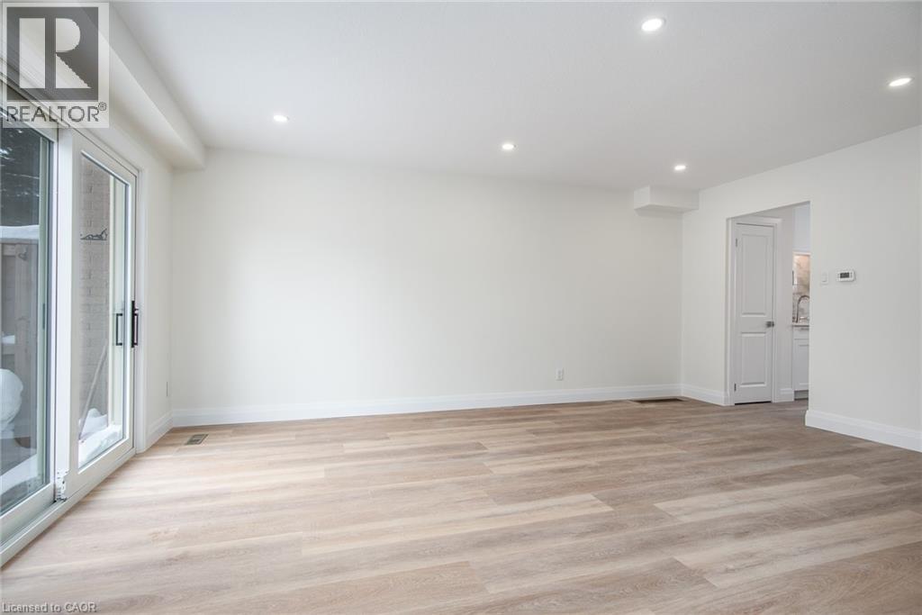 Empty room with light wood-type flooring and recessed lighting