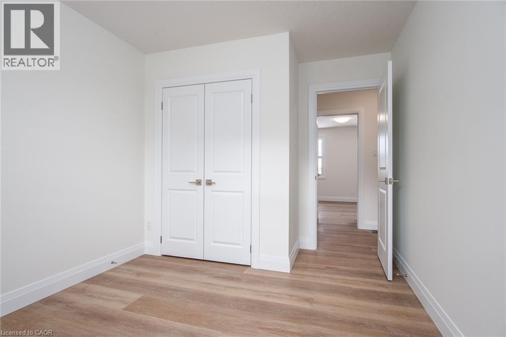 Unfurnished bedroom featuring light wood finished floors and a closet