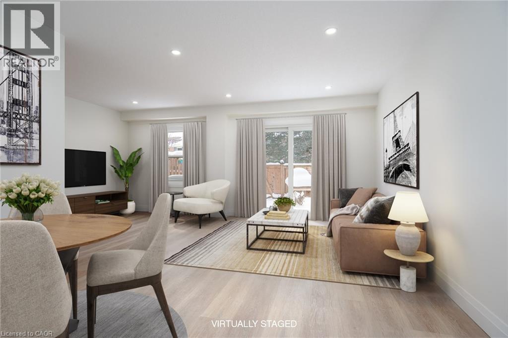 Living room with light wood-style floors, healthy amount of natural light, and recessed lighting