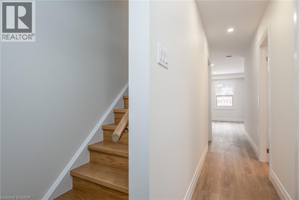 Corridor with light wood-style flooring and recessed lighting