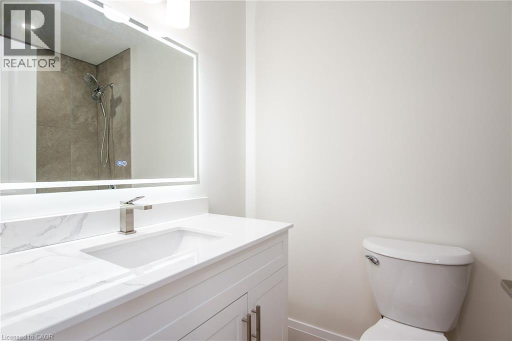 Full bath featuring vanity and a tile shower