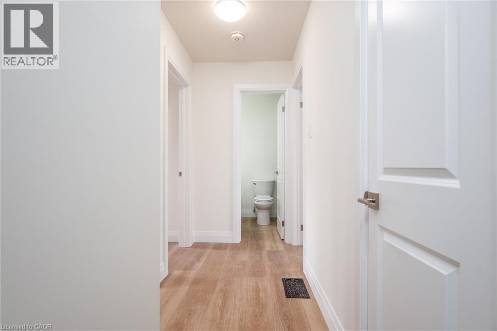 Corridor with baseboards and light wood-type flooring