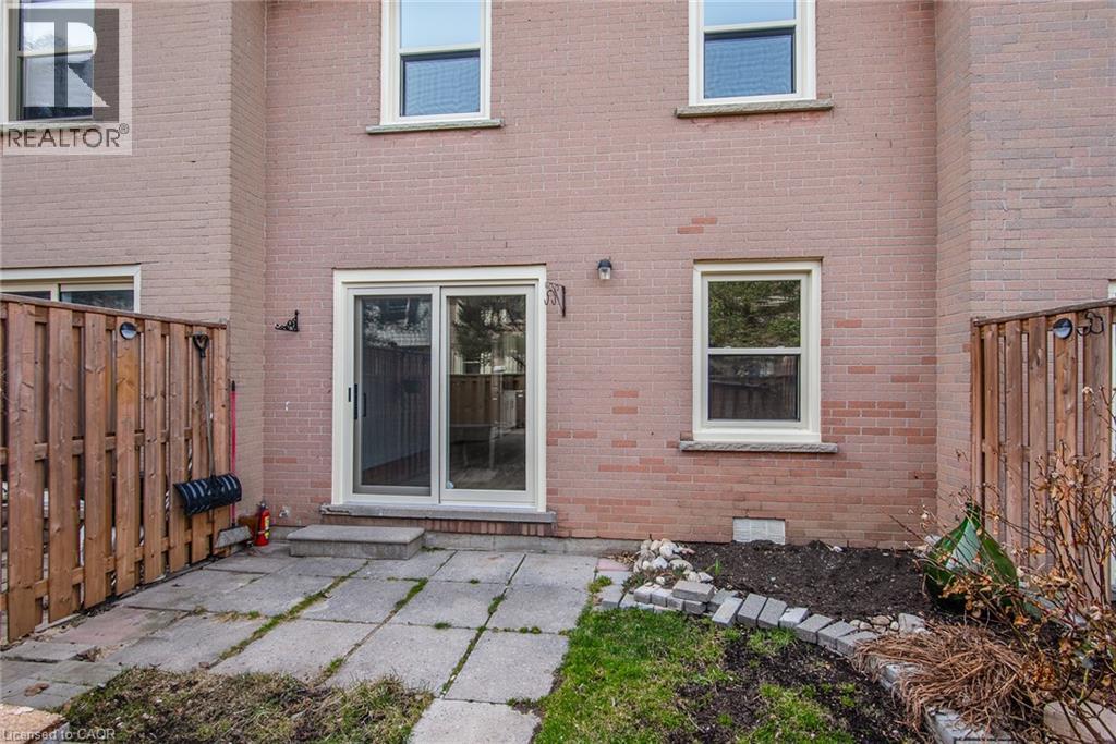 Rear view of house featuring brick siding and a patio