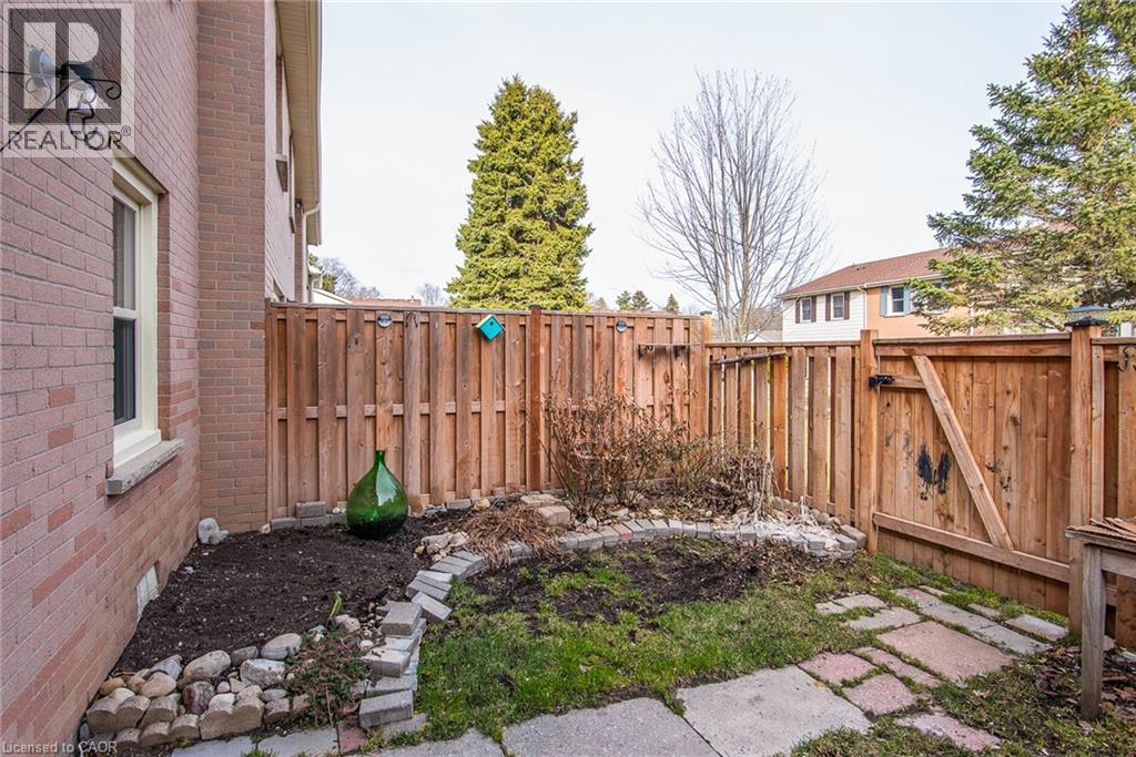 Fenced backyard featuring a gate